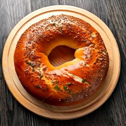 "Freshly baked homemade sourdough bagels with a golden-brown crust."
